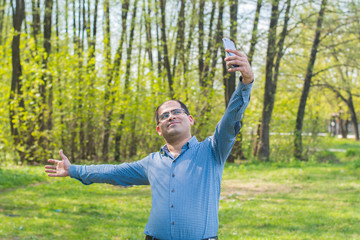 young man taking selfie in the forest