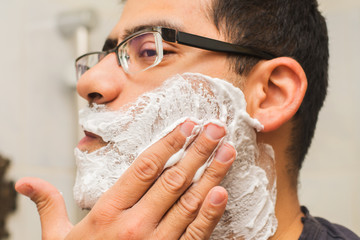 man shaves face close-up