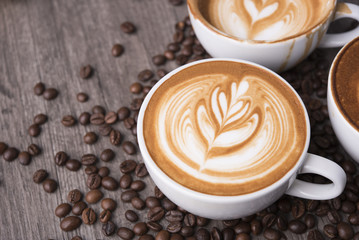 latte or Cappuccino with frothy foam, coffee cup top view on table in cafe. - obrazy, fototapety, plakaty