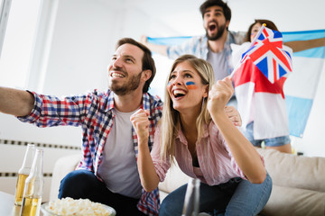 Group of multi-ethnic people celebrating football game