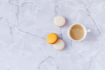 a cup of coffee with sweets on a gray marble background. Copy space. Selective focus.