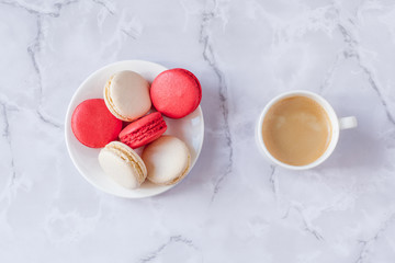 a cup of coffee with sweets on a gray marble background. Copy space. Selective focus.