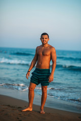 Fototapeta na wymiar Portrait of an attractive young man on a tropical beach