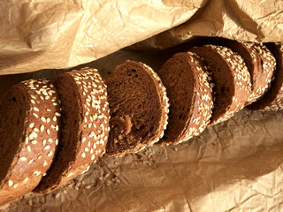 Bread with sesame seeds on a background of brown paper.