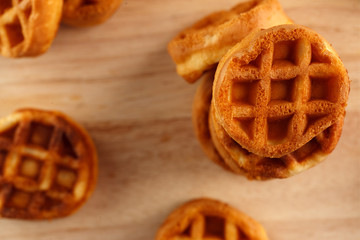 circle mini waffles on wooden cutting board. Top view