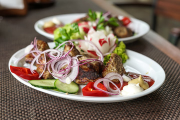 Barbecue with vegetables and sauce