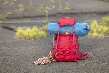 Red backpack on volcanic terrain