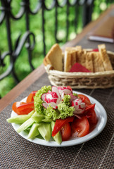 Barbecue with vegetables, sauce and bread