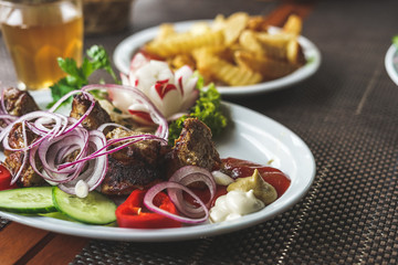 Shish kebab with vegetables and french fries