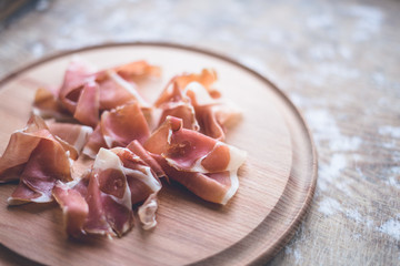 Italian jamon on  wooden round board