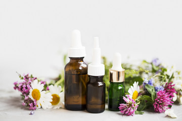Fototapeta na wymiar Essential oils with medicinal plants and flowers