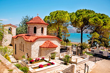 Beautiful landscape with an ancient church at the cemetery near the sea in Argostoli, Kefalonia, Greece.  Stunning amazing charming places. prominent tourist towns. - Powered by Adobe
