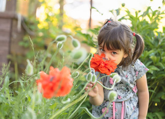 Portrait of a three year old little girl outdoor in  garden.