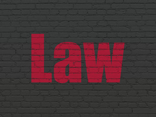 Law concept: Painted red text Law on Black Brick wall background