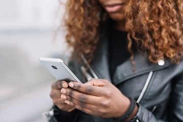 Close up view of curly-haired woman with phone