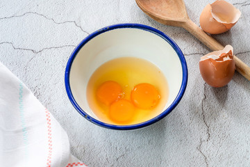 Three egg yolks in a bowl - high angle view