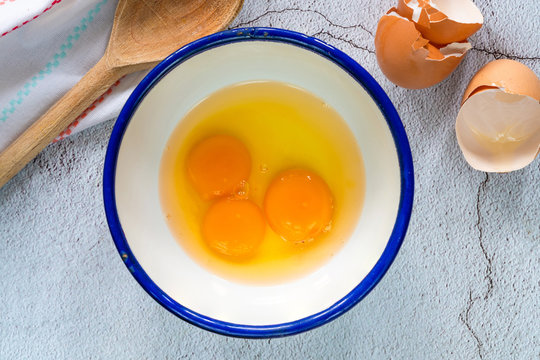 Three egg yolks in a bowl - top view