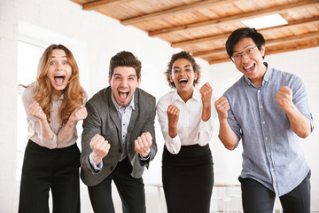 Group of cheerful young multiethnic businesspeople