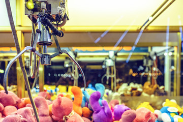 Night view to claw machine full of colorful soft toys