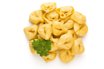 Raw homemade pasta,tortellini with herbs.