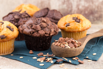 Homemade muffins with chocolate, vintage background.