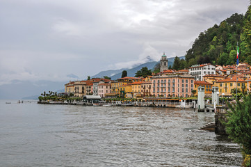 View of Lake Como in cloudy day with the buildings of Bellagio, a charming tourist village between the lake and the mountains of the Alps. Located in the Lombardy region, northern Italy