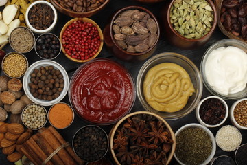 different spices on wooden background. top view