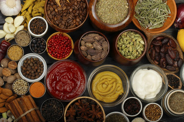 different spices on wooden background. top view