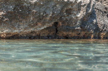 Stone rock cliff with sea foreground