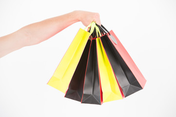 Male hand holds five shopping bags. Shopping concept. Hand holds bunch of colorful shopping bags....
