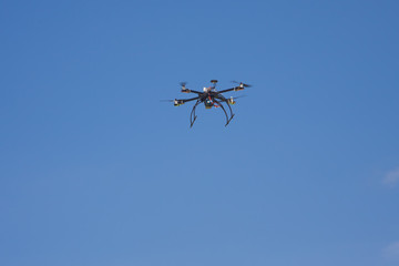 Fototapeta na wymiar quadcopter drone for hobby on clear blue sky background