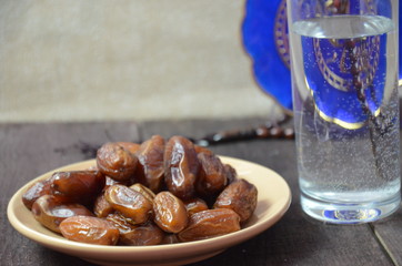 A glass of drinking water and date fruits - a food that is consumed before breaking fast during holy month of Ramadan.