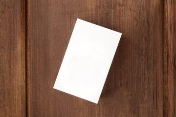 White business card mockup on a dark background, overhead photo with copy space