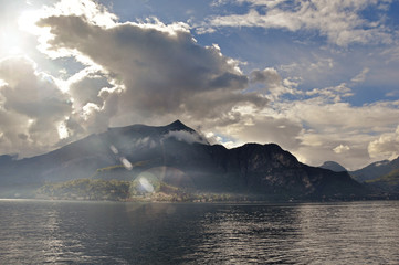 View of Lake Como in a cloudy day with sunshine in Bellagio, a charming tourist village between the lake and the mountains of the Alps. Located in the Lombardy region, northern Italy