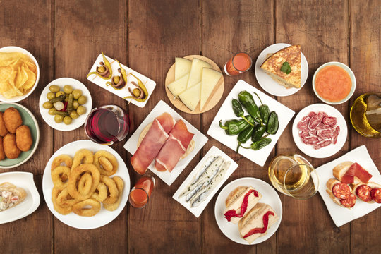 Spanish tapas food on dark background with wine and place for text