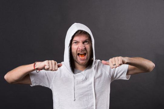 Bearded man show fists. Angry man with beard wear hood. Fashion model in hoodie tshirt. Active lifestyle and health activity. Fashion style and trend concept