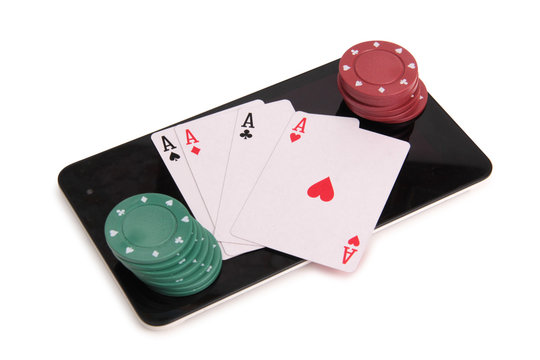 Playing cards and chips with a tablet on a white background