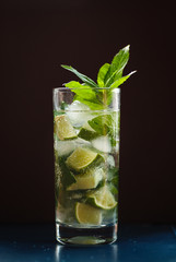 Mojito in a glass and lime, ice and green mint.