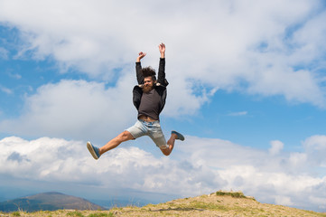 Hipster or brutal macho conquers mountain. Man with brutal appearance jumps. Freedom concept. Man...