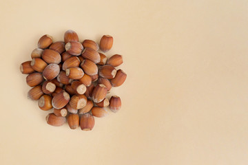 Group of hazelnuts on yellow background