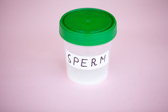 Health. Donor Sperm. Close up Concept of Bank Sperm. Infertility Bank with Sperm. Sperm Analysis on Pink Background.