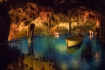 Inside Drach cave of Mallorca with geological minerals and blue lake in Spain