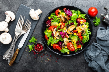 Salad with fresh and grilled vegetables and mushrooms. Vegetable salad with grilled champignons. Vegetable salad on plate. Healthy vegetarian food