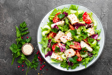 Meat salad with fresh vegetables. Vegetable salad with baked chicken breast. Vegetable salad with chicken fillet on plate