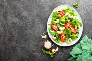 Salad with fresh vegetables and nuts. Vegetable salad with fresh vegetables and cashew. Vegetable salad on plate. Healthy vegetarian food