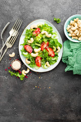 Salad with fresh vegetables and nuts. Vegetable salad with fresh vegetables and cashew. Vegetable salad on plate. Healthy vegetarian food