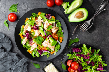 Salad with fish. Fresh vegetable salad with salmon fish fillet. Fish salad with salmon fillet and fresh vegetables on plate
