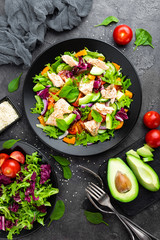 Salad with fish. Fresh vegetable salad with salmon fish fillet. Fish salad with salmon fillet and fresh vegetables on plate