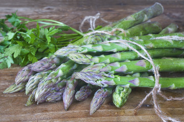 Fresh green asparagus and parsley, close up, selective focus,