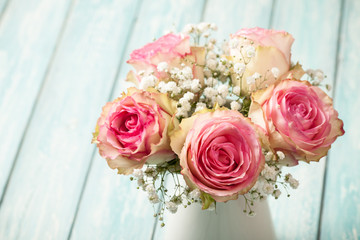 Pink roses on blue background